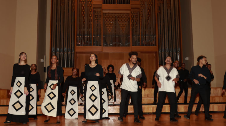 Color photo of South African choir singing on stage.